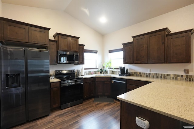 kitchen with appliances with stainless steel finishes, dark wood-style flooring, light stone counters, and dark brown cabinets