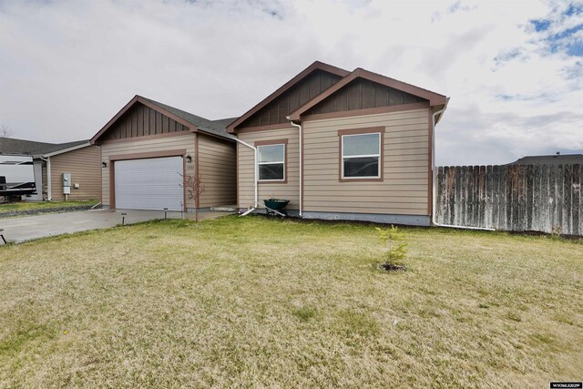 view of front of property featuring an attached garage, a front lawn, board and batten siding, and driveway