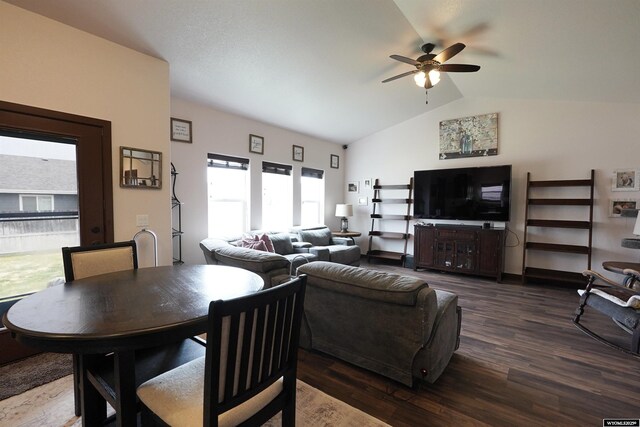 living area with ceiling fan, vaulted ceiling, and wood finished floors