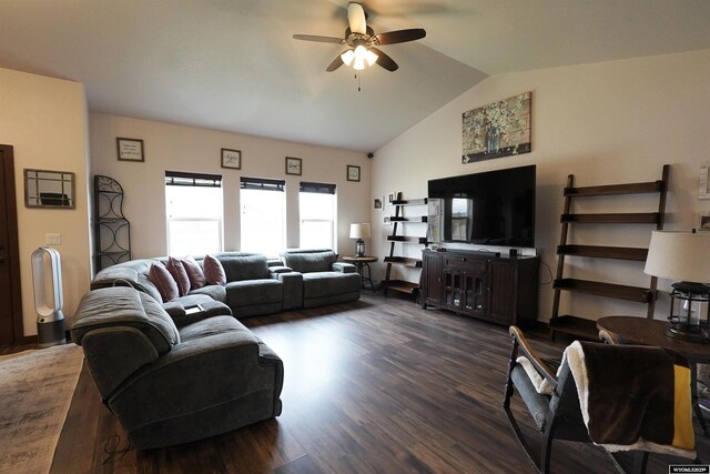 living area featuring a ceiling fan, vaulted ceiling, and wood finished floors