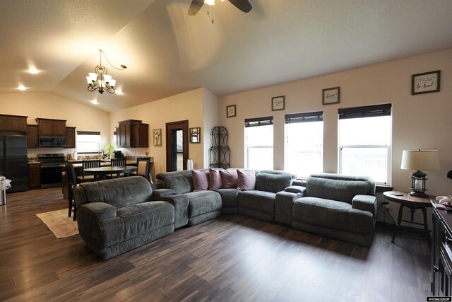 living room with ceiling fan with notable chandelier, dark wood-style flooring, and lofted ceiling