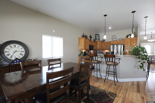 dining area featuring light wood-type flooring