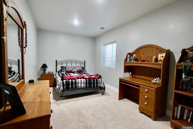 bedroom with baseboards, visible vents, and carpet