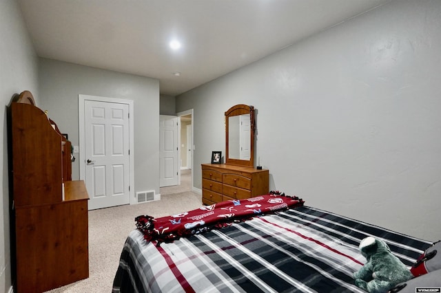 bedroom with carpet floors, baseboards, and visible vents
