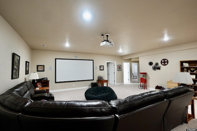 home theater with baseboards, light colored carpet, and visible vents