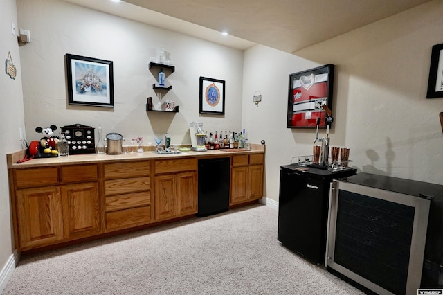 bar with bar, light colored carpet, fridge, baseboards, and wine cooler
