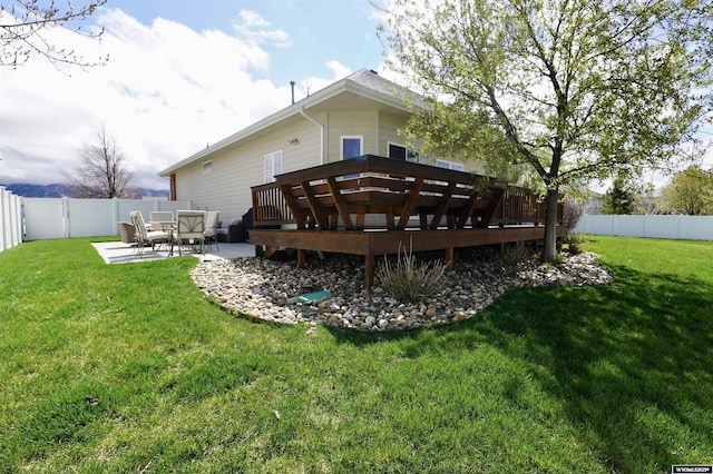 back of house with a yard, a deck, a fenced backyard, and a patio area