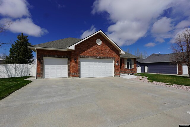 single story home with fence, a shingled roof, brick siding, a garage, and driveway