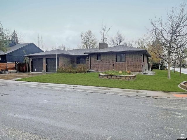 ranch-style house featuring an attached garage, a front lawn, and brick siding