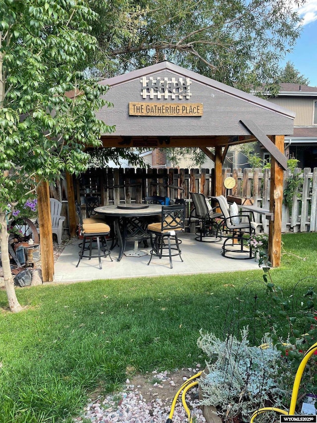 view of home's community featuring a patio area, fence, and a yard