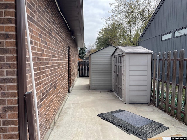 exterior space with fence, an outdoor structure, and a shed
