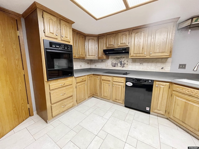 kitchen with a sink, decorative backsplash, under cabinet range hood, and black appliances
