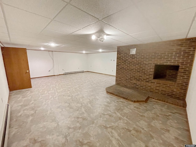 finished basement with baseboard heating and a drop ceiling