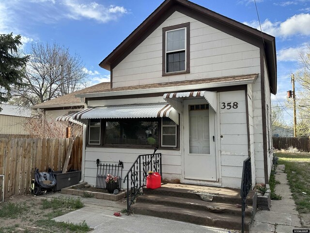 358 E 5th Ave, Torrington, WY 82240 - view of front of home featuring fence and a shingled roof