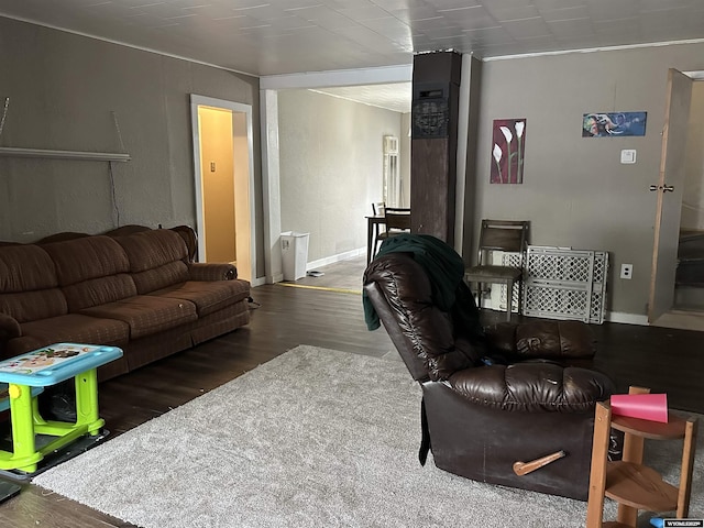 living area featuring baseboards and wood finished floors