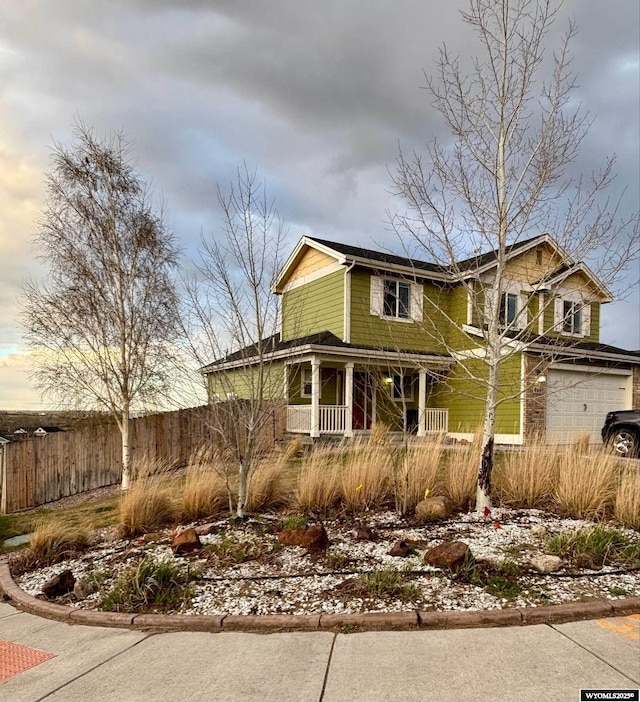 999 Eagle Dr, Douglas, WY 82633 - view of front of home featuring a porch, fence, and a garage
