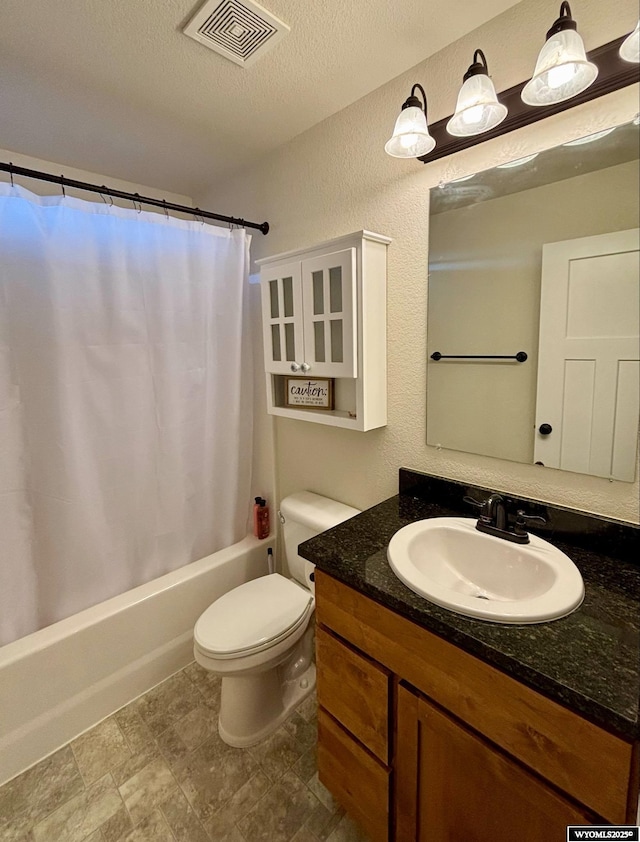 999 Eagle Dr, Douglas, WY 82633 - bathroom with vanity, toilet, shower / bath combination with curtain, a textured ceiling, and a textured wall