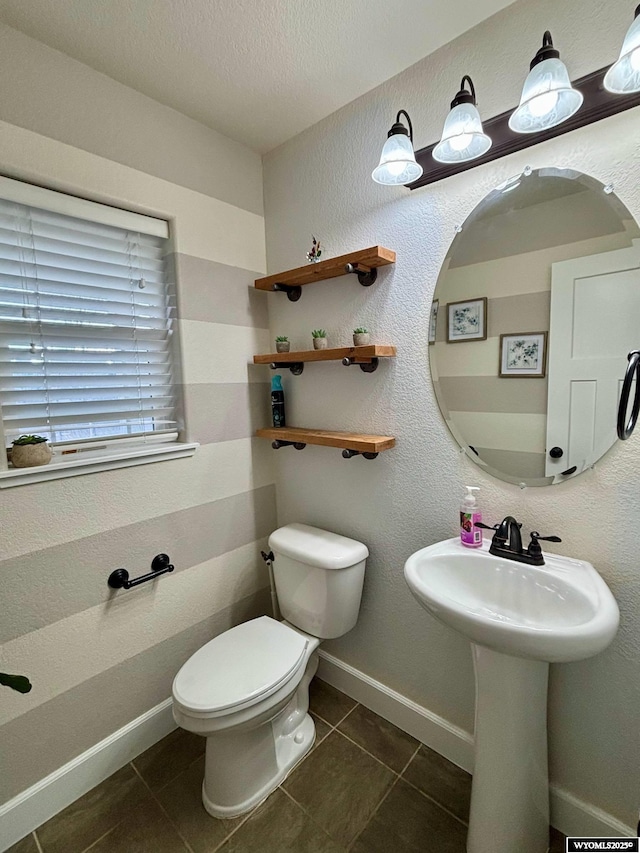 999 Eagle Dr, Douglas, WY 82633 - half bath featuring tile patterned floors, toilet, and baseboards