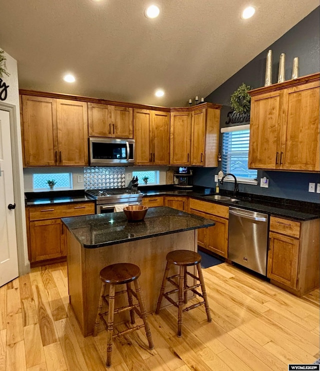 999 Eagle Dr, Douglas, WY 82633 - kitchen with appliances with stainless steel finishes, a sink, light wood-type flooring, brown cabinets, and recessed lighting