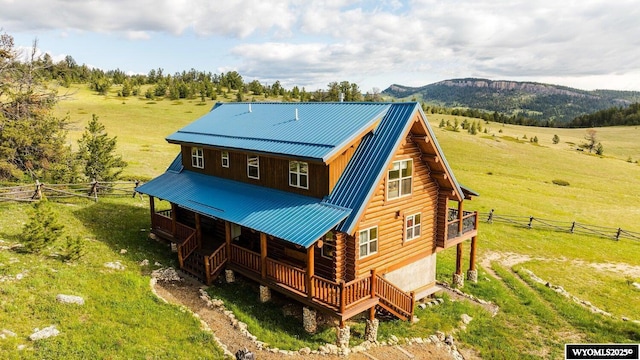 18 High Meadows Rd, Buffalo, WY 82834 - rear view of house featuring fence, a deck, log siding, a rural view, and metal roof