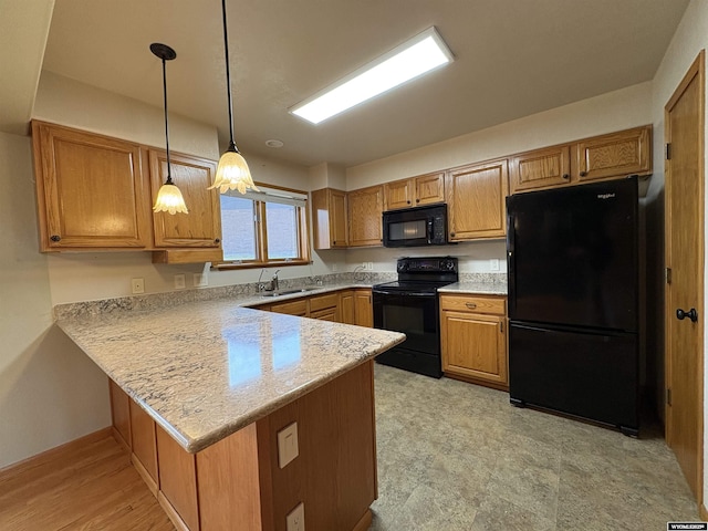 2327 Crestview Dr, Torrington, WY 82240 - kitchen featuring a sink, light countertops, a peninsula, decorative light fixtures, and black appliances
