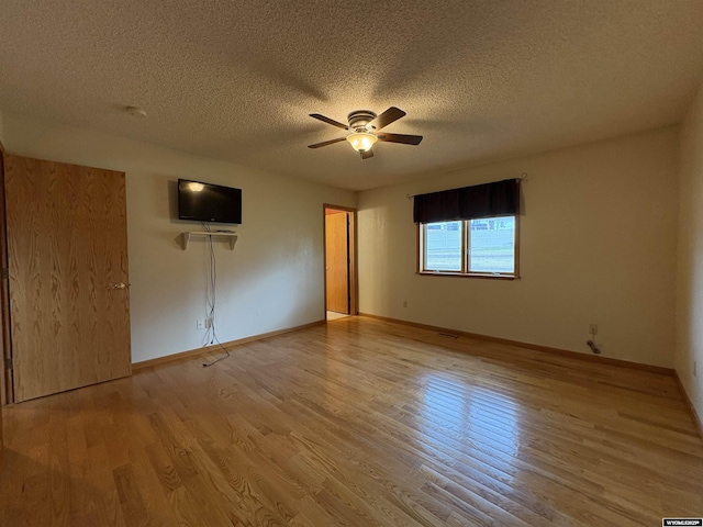 2327 Crestview Dr, Torrington, WY 82240 - unfurnished room featuring baseboards, a ceiling fan, a textured ceiling, and wood finished floors