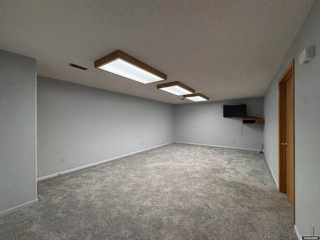 2327 Crestview Dr, Torrington, WY 82240 - finished basement with baseboards, carpet flooring, a textured ceiling, and visible vents