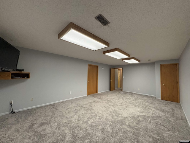 2327 Crestview Dr, Torrington, WY 82240 - unfurnished room featuring carpet floors, baseboards, a textured ceiling, and visible vents
