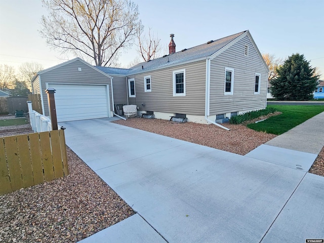 view of home's exterior featuring a garage, roof with shingles, fence, and a chimney