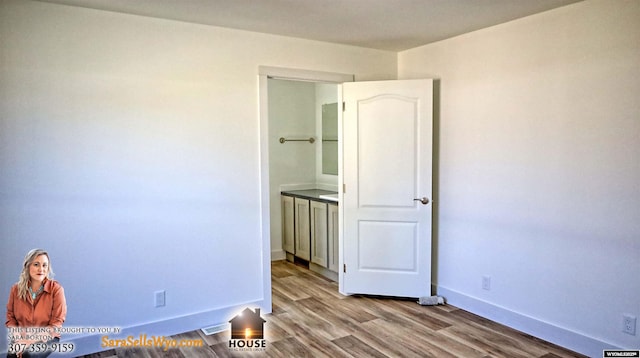 unfurnished bedroom featuring baseboards and light wood-type flooring
