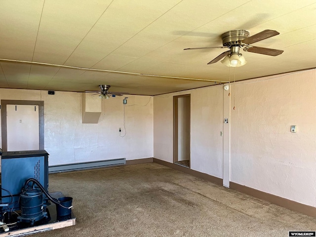 spare room featuring baseboards, baseboard heating, a ceiling fan, and carpet flooring