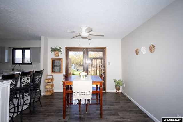 dining space featuring baseboards, dark wood-style floors, and plenty of natural light