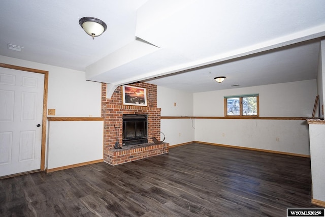 unfurnished living room featuring baseboards, wood finished floors, and a fireplace