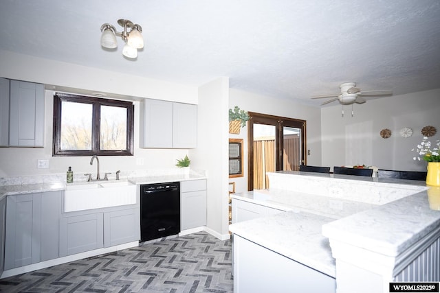 kitchen featuring a sink, ceiling fan, a textured ceiling, and dishwasher
