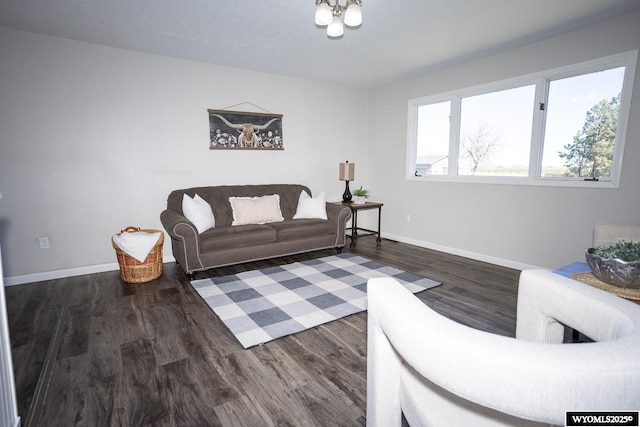 living area with baseboards and wood finished floors