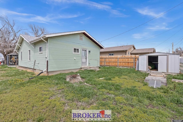 1105 N Elma, Casper, WY 82601 - rear view of property featuring fence, a storage unit, an outbuilding, and a yard