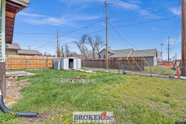 1105 N Elma, Casper, WY 82601 - view of yard featuring an outdoor structure, a fenced backyard, and a storage shed