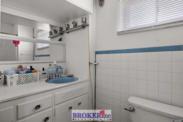 1105 N Elma, Casper, WY 82601 - bathroom with toilet, tile walls, wainscoting, and vanity