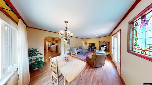 94 Grandview Ln, Riverton, WY 82501 - dining space featuring an inviting chandelier, arched walkways, wood finished floors, and ornamental molding