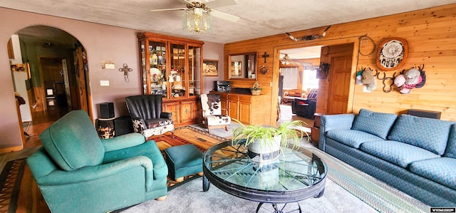 5421 S Okeepa, Casper, WY 82604 - living area featuring arched walkways, ceiling fan, and wooden walls