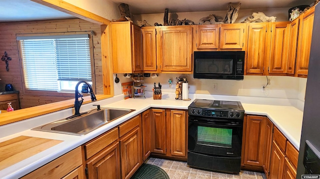 5421 S Okeepa, Casper, WY 82604 - kitchen with a sink, light countertops, black appliances, and brown cabinets
