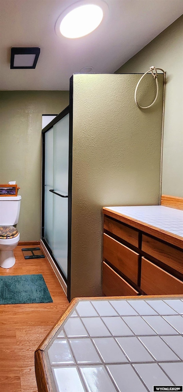5421 S Okeepa, Casper, WY 82604 - bathroom with a shower stall, toilet, and wood finished floors