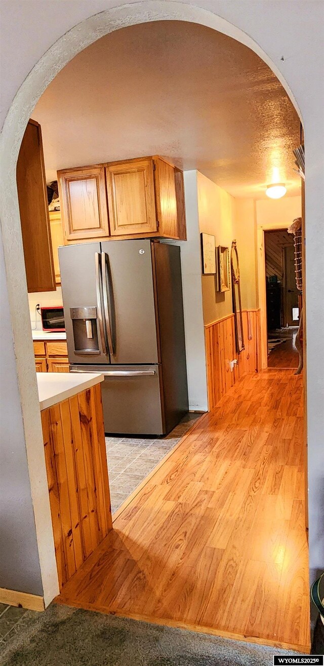 5421 S Okeepa, Casper, WY 82604 - kitchen with light countertops, arched walkways, and stainless steel fridge with ice dispenser