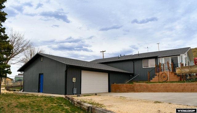 5421 S Okeepa, Casper, WY 82604 - view of front facade with roof with shingles, an attached garage, and driveway