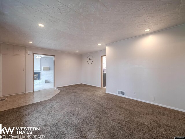 carpeted spare room featuring baseboards, recessed lighting, and visible vents