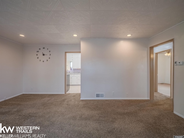 empty room featuring visible vents, recessed lighting, carpet, and baseboards