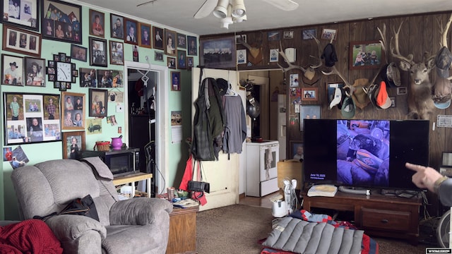 interior space with carpet flooring and wooden walls
