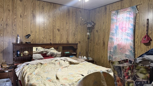 bedroom featuring wood walls