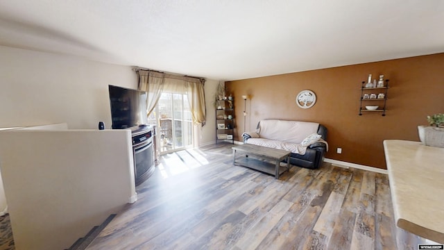 living room featuring baseboards and wood finished floors