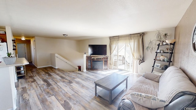 living room with baseboards and wood finished floors